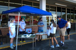 Image of Volunteers Giving Out Masks At Food World